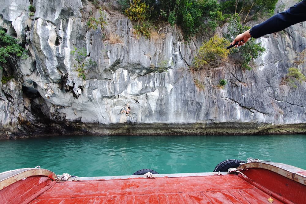 From the boat, our guide points the laser pointer at the next hold on the climb